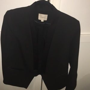 Black blazer with tuxedo lapel.